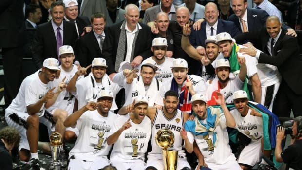 Jun 15, 2014; San Antonio, TX, USA; San Antonio Spurs pose for a photo with the Larry O'Brien trophy after the game against the Miami Heat in game five of the 2014 NBA Finals at AT&amp;T Center. The Spurs defeated the Heat 104-87 to win the NBA Finals. Mandatory Credit: Soobum Im-USA TODAY Sports