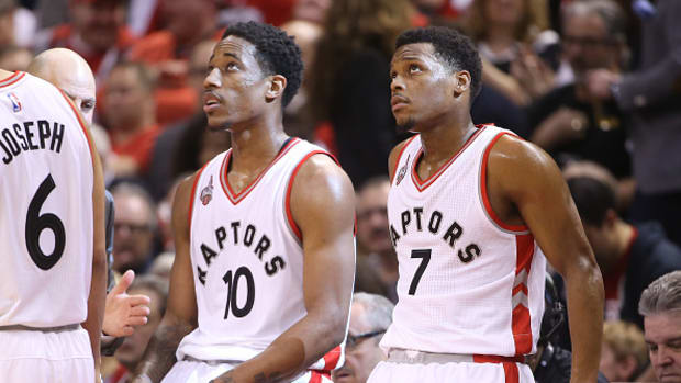 TORONTO, CANADA - APRIL 16: Kyle Lowry #7 (R) of the Toronto Raptors and DeMar DeRozan #10 (L) look on against the Indiana Pacers in Game One of the Eastern Conference Quarterfinals during the 2016 NBA Playoffs on April 16, 2016 at the Air Canada Centre in Toronto, Ontario, Canada. NOTE TO USER: User expressly acknowledges and agrees that, by downloading and or using this photograph, User is consenting to the terms and conditions of the Getty Images License Agreement. (Photo by Tom Szczerbowski/Getty Images)