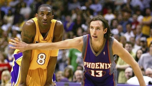 LOS ANGELES - MAY 4:  Steve Nash #13 of the Phoenix Suns puts his arm in front of Kobe Bryant #8 of the Los Angeles Lakers in game six of the Western Conference Quarterfinals during the 2006 NBA Playoffs on May 4, 2006 at the Staples Center in Los Angeles, California. The Suns defeated the Lakers 126-118 in overtime to tie the series 3-3.  NOTE TO USER: User expressly acknowledges and agrees that, by downloading and/or using this Photograph, user is consenting to the terms and conditions of the Getty Images License Agreement.  (Photo by Harry How/Getty Images)