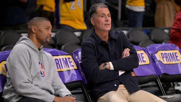 Nov 21, 2024; Los Angeles, California, USA; Los Angeles Lakers general manager Rob Pelinka, right, talks with Leroy Sims, director of player performance & health, prior to the game against the Orlando Magic at Crypto.com Arena. Mandatory Credit: Jayne Kamin-Oncea-Imagn Images  