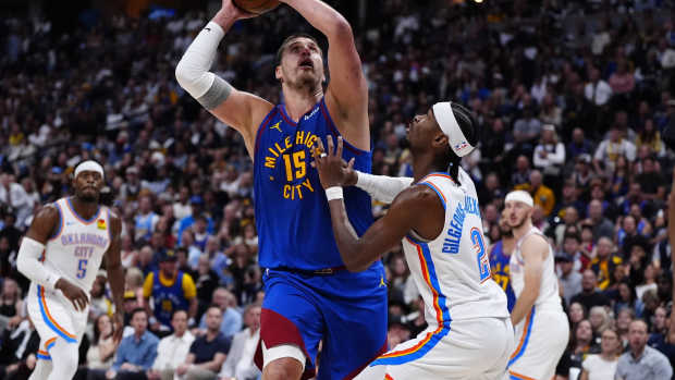 May 9, 2025; Denver, Colorado, USA; Oklahoma City Thunder guard Shai Gilgeous-Alexander (2) defends on Denver Nuggets center Nikola Jokic (15) in the second half during game three of the second round for the 2025 NBA Playoffs at Ball Arena.