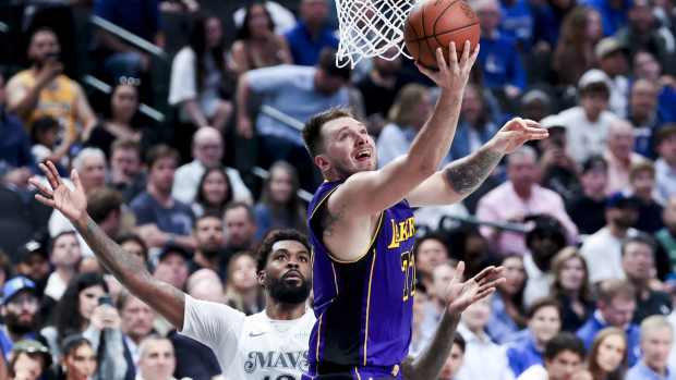Los Angeles Lakers guard Luka Doncic (77) shoots past Dallas Mavericks forward Naji Marshall (13) during the second quarter at American Airlines Center.