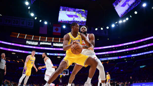 Mar 6, 2025; Los Angeles, California, USA; Los Angeles Lakers center Trey Jemison III (55) moves the ball against New York Knicks center Mitchell Robinson (23) during the second half at Crypto.com Arena. Mandatory Credit: Gary A. Vasquez-Imagn Images