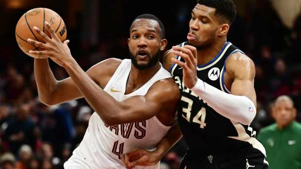 Dec 20, 2024; Cleveland, Ohio, USA; Cleveland Cavaliers forward Evan Mobley (4) drives to the basket against Milwaukee Bucks forward Giannis Antetokounmpo (34) during the second half at Rocket Mortgage FieldHouse.