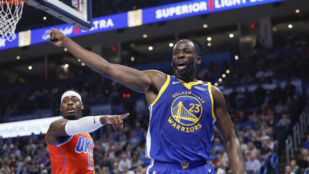 Golden State Warriors forward Draymond Green (23) and Oklahoma City Thunder guard Luguentz Dort (5) react after a play during the second quarter at Paycom Center.