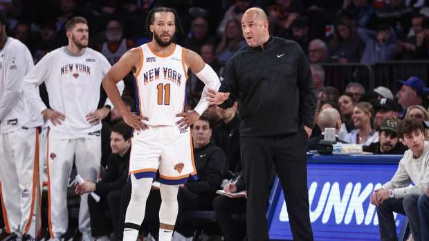 Dec 1, 2024; New York, New York, USA; New York Knicks guard Jalen Brunson (11) talks with Assistant Coach Rick Brunson in the third quarter against the New Orleans Pelicans at Madison Square Garden.