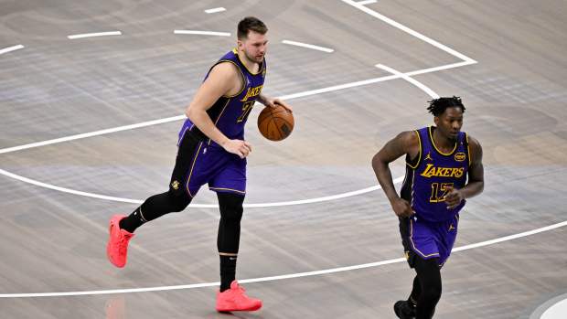 Apr 9, 2025; Dallas, Texas, USA; Los Angeles Lakers guard Luka Doncic (77) and forward Dorian Finney-Smith (17) in action during the game between the Dallas Mavericks and the Los Angeles Lakers at American Airlines Center. Mandatory Credit: Jerome Miron-Imagn Images