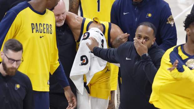 Jun 22, 2025; Oklahoma City, Oklahoma, USA; Indiana Pacers guard Tyrese Haliburton (0) is assisted after an apparent injury following a play against the Oklahoma City Thunder during the first half of game seven of the 2025 NBA Finals at Paycom Center. Mandatory Credit: Alonzo Adams-Imagn Images