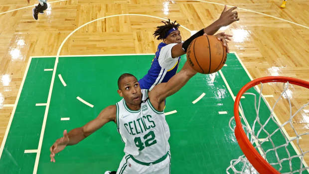 Jun 16, 2022; Boston, Massachusetts, USA; Boston Celtics center Al Horford (42) grabs a rebound against Golden State Warriors center Kevon Looney (5) in game six of the 2022 NBA Finals at TD Garden.