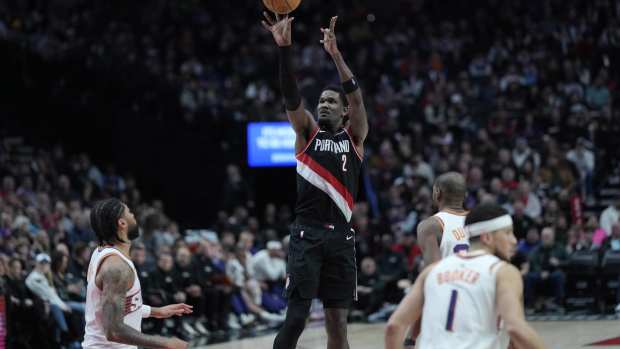 Feb 1, 2025; Portland, Oregon, USA; Portland Trail Blazers center Deandre Ayton (2, left) shoots the ball over Phoenix Suns center Nick Richards (2) during the second half at Moda Center. Mandatory Credit: Soobum Im-Imagn Images