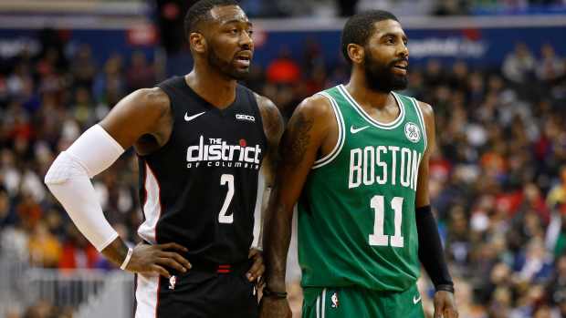 Washington, DC, USA; Washington Wizards guard John Wall (2) talks with Boston Celtics guard Kyrie Irving (11) in the fourth quarter at Capital One Arena. Mandatory Credit: Geoff Burke-Imagn Images