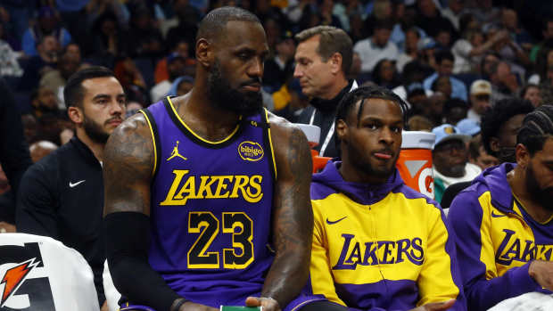 Los Angeles Lakers forward LeBron James (23) and Los Angeles Lakers guard Bronny James (9) sit on the bench during the first half against the Memphis Grizzlies at FedExForum.