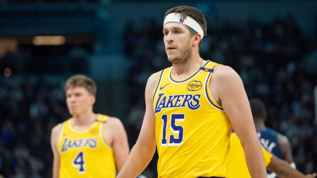 Los Angeles Lakers guard Austin Reaves (15) and teammates head to the bench for the break after the first quarter against the Minnesota Timberwolves at Target Center.