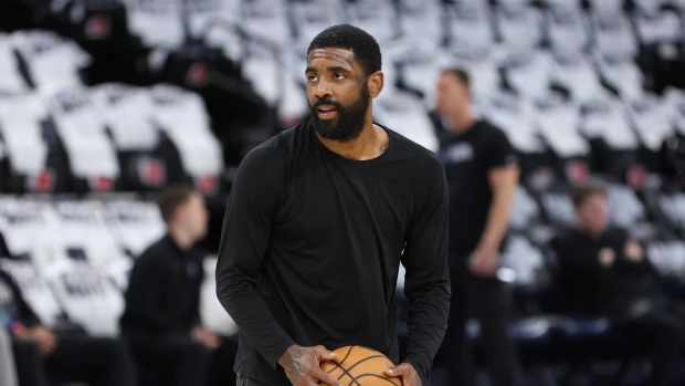 Dallas Mavericks guard Kyrie Irving (11) warms up before the game against the Minnesota Timberwolves in game two of the Western Conference finals for the 2024 NBA playoffs at Target Center.
