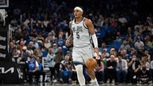 Mar 27, 2025; Orlando, Florida, USA; Orlando Magic forward Paolo Banchero (5) dribbles the ball against the Dallas Mavericks in the third quarter at Kia Center. Mandatory Credit: Jeremy Reper-Imagn Images