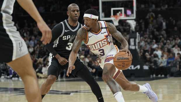Phoenix Suns guard Bradley Beal (3) drives to the basket against San Antonio Spurs guard Chris Paul (3) during the first half at Moody Center.
