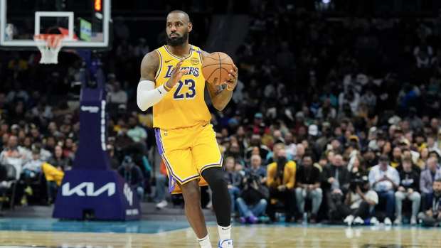 Jan 27, 2025; Charlotte, North Carolina, USA; Los Angeles Lakers forward LeBron James (23) brings the ball up court against the Charlotte Hornets during the first quarter at the Spectrum Center. Mandatory Credit: Jim Dedmon-Imagn Images