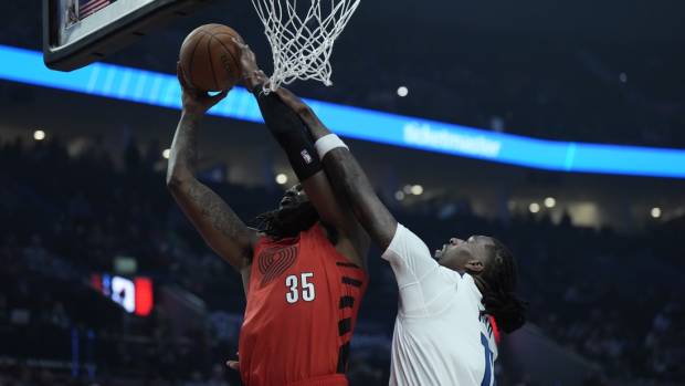 Portland Trail Blazers center Robert Williams III (35) shoots the ball against Minnesota Timberwolves center Naz Reid (11) during the first half at Moda Center. Mandatory Credit: Soobum Im-Imagn Images