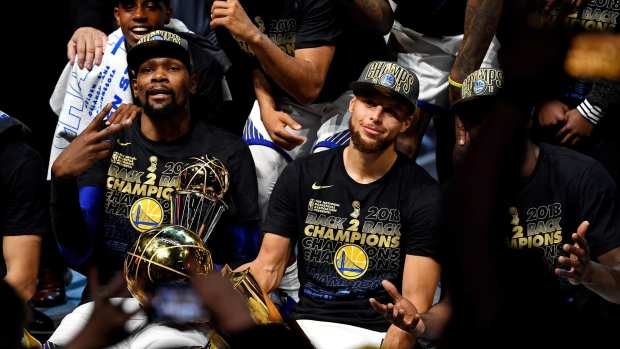 Golden State Warriors forward Kevin Durant (35) and guard Stephen Curry (30) celebrate after beating the Cleveland Cavaliers in game four of the 2018 NBA Finals at Quicken Loans Arena.