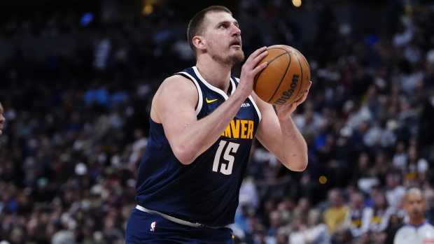 Denver Nuggets center Nikola Jokic (15) prepares to shoot the ball in the second half against the Utah Jazz at Ball Arena.