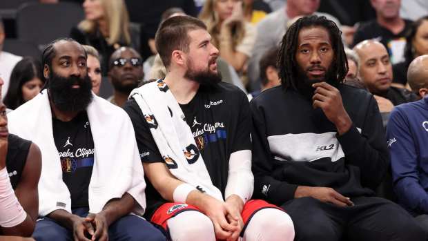 Nov 22, 2024; Inglewood, California, USA; Los Angeles Clippers guard James Harden (1, left) and center Ivica Zubac (40, center), and Kawhi Leonard (right) watch a game from the bench during the second half against the Sacramento Kings at Intuit Dome.