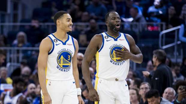 Oct 14, 2022; San Francisco, California, USA; Golden State Warriors guard Jordan Poole (3) and forward Draymond Green (23) re-enter the court after a time-out during the first half of the game against the Denver Nuggets at Chase Center.