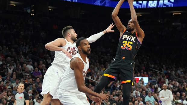 Apr 3, 2024; Phoenix, Arizona, USA; Phoenix Suns forward Kevin Durant (35) shoots over Cleveland Cavaliers guard Max Strus (1) during the first half at Footprint Center.