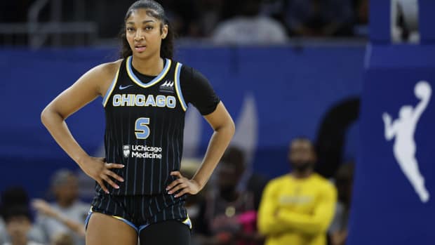 Chicago Sky forward Angel Reese (Center) standing on the basketball court during a WNBA game.