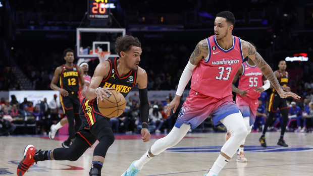 Mar 8, 2023; Washington, District of Columbia, USA; Atlanta Hawks guard Trae Young (11) drives to the basket as Washington Wizards forward Kyle Kuzma (33) defends in the first quarter at Capital One Arena.