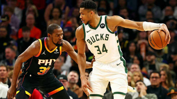 Feb 6, 2024; Phoenix, Arizona, USA; Milwaukee Bucks forward Giannis Antetokounmpo (34) handles the ball against the Phoenix Suns forward Kevin Durant (35) during the third quarter at Footprint Center. Mandatory Credit: Mark J. Rebilas-Imagn Images  