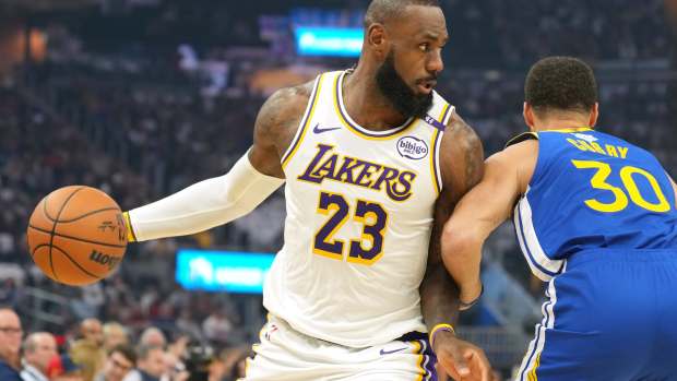 Los Angeles Lakers forward LeBron James (23) dribbles against Golden State Warriors guard Stephen Curry (30) during the first quarter at Chase Center. Mandatory Credit: Darren Yamashita-Imagn Images