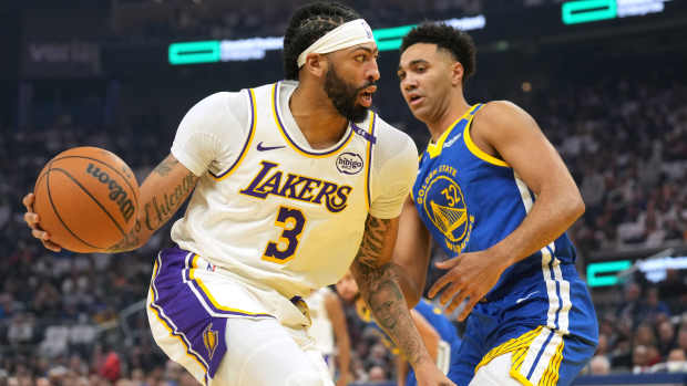  Los Angeles Lakers forward Anthony Davis (3) dribbles against Golden State Warriors forward Trayce Jackson-Davis (32) during the first quarter at Chase Center. Mandatory Credit: Darren Yamashita-Imagn Images