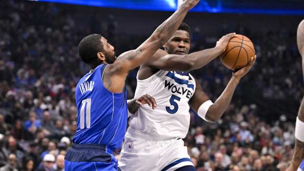 Minnesota Timberwolves guard Anthony Edwards (5) looks to pass the ball past Dallas Mavericks guard Kyrie Irving (11) during the first quarter at the American Airlines Center. Mandatory Credit: Jerome Miron-Imagn Images