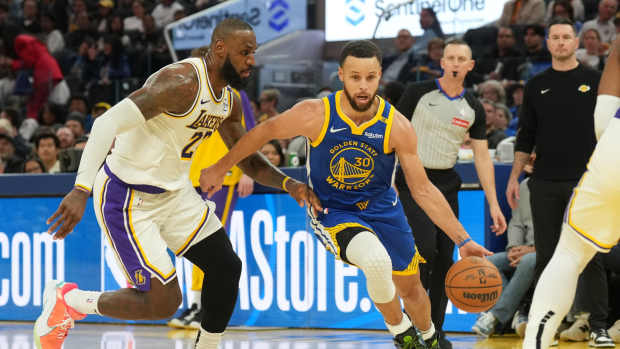  Golden State Warriors guard Stephen Curry (30) dribbles against Los Angeles Lakers forward LeBron James (left) during the third quarter at Chase Center. Mandatory Credit: Darren Yamashita-Imagn Images