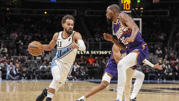 Atlanta Hawks guard Trae Young (11) dribbles against Phoenix Suns forward Kevin Durant (35) during the first half at State Farm Arena. Mandatory Credit: Dale Zanine-Imagn Images