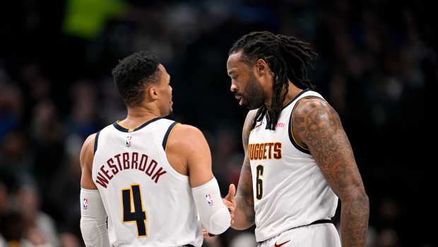 Jan 14, 2025; Dallas, Texas, USA; Denver Nuggets guard Russell Westbrook (4) and center DeAndre Jordan (6) talk during the second quarter against the Dallas Mavericks at the American Airlines Center. Mandatory Credit: Jerome Miron-Imagn Images  