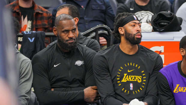 Los Angeles Lakers forward LeBron James (23) and forward Anthony Davis (3) on the bench against the Minnesota Timberwolves in the fourth quarter at Target Center. Mandatory Credit: Brad Rempel-Imagn Images