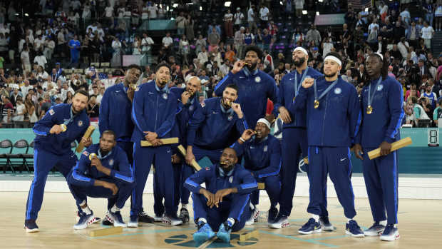 Team USA celebrates with the gold medal after the game against France in the men's basketball gold medal game during the Paris 2024 Olympic Summer Games at Accor Arena.