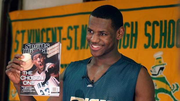 LeBron James holds an issue of Sports Illustrated on Feb. 13, 2002. James was on SI's cover as a junior at St. Vincent-St. Mary High School. Cover Boy Is All Smiles  