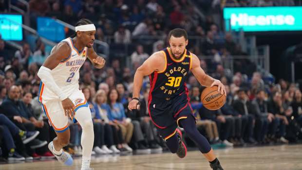 Golden State Warriors guard Stephen Curry (30) dribbles the ball against Oklahoma City Thunder guard Shai Gilgeous-Alexander (2) in the first quarter at the Chase Center. Mandatory Credit: Cary Edmondson-Imagn Images