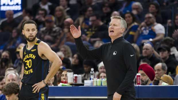 Dec 30, 2024; San Francisco, California, USA; Golden State Warriors guard Stephen Curry (30) watches as head coach Steve Kerr reacts during the first quarter of the game against the Cleveland Cavaliers against the Cleveland Cavaliers at Chase Center. Mandatory Credit: John Hefti-Imagn Images