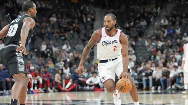 Jan 29, 2025; San Antonio, Texas, USA; LA Clippers forward Kawhi Leonard (2) dribbles in front of San Antonio Spurs forward Harrison Barnes (40) in the first half at Frost Bank Center. Mandatory Credit: Daniel Dunn-Imagn Images