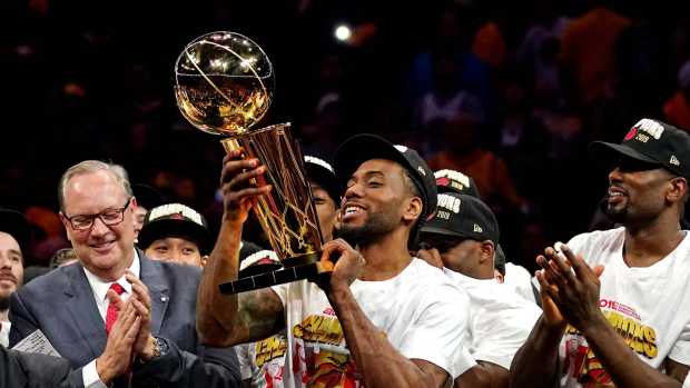 Jun 13, 2019; Oakland, CA, USA; Toronto Raptors forward Kawhi Leonard (2) celebrates with the Larry O'Brien Trophy after the Golden State Warriors in game six of the 2019 NBA Finals at Oracle Arena. Mandatory Credit: Kyle Terada-Imagn Images