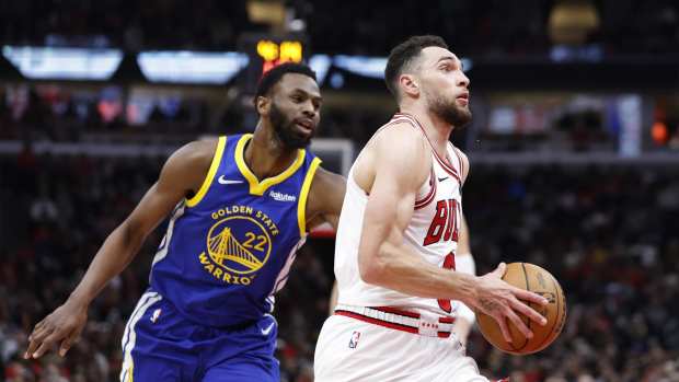 Jan 12, 2024; Chicago, Illinois, USA; Chicago Bulls guard Zach LaVine (8) drives against Golden State Warriors forward Andrew Wiggins (22) during the second half at United Center. Mandatory Credit: Kamil Krzaczynski-Imagn Images