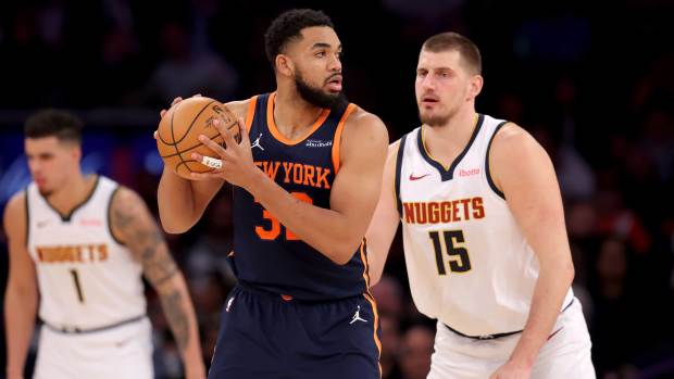 Jan 29, 2025; New York, New York, USA; New York Knicks center Karl-Anthony Towns (32) controls the ball against Denver Nuggets center Nikola Jokic (15) during the third quarter at Madison Square Garden. Mandatory Credit: Brad Penner-Imagn Images