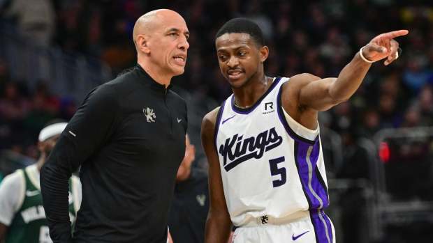  Sacramento Kings guard De'Aaron Fox (5) talks to interim head coach Doug Christie in the second quarter against the Milwaukee Bucks at Fiserv Forum. Mandatory Credit: Benny Sieu-Imagn Images