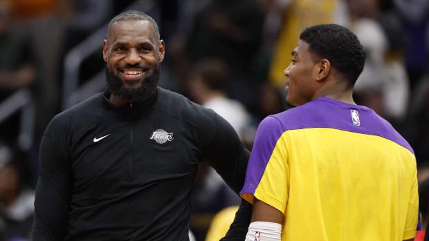 Jan 29, 2025; Washington, District of Columbia, USA; Los Angeles Lakers forward LeBron James (L) and Lakers forward Rui Hachimura (R) joke on the bench against the Washington Wizards in the third quarter at Capital One Arena.