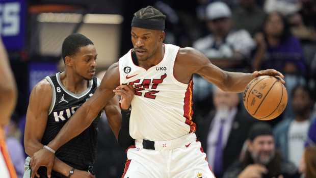 Miami Heat forward Jimmy Butler (22) dribbles the ball against Sacramento Kings guard De'Aaron Fox (5) during the third quarter at Golden 1 Center. Mandatory Credit: Darren Yamashita-Imagn Images