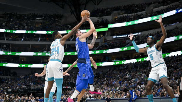 Nov 5, 2023; Dallas, Texas, USA; Dallas Mavericks guard Luka Doncic (77) shoots the ball between Charlotte Hornets forward Brandon Miller (24) and center Mark Williams (5) during the first quarter at the American Airlines Center. Mandatory Credit: Jerome Miron-Imagn Images