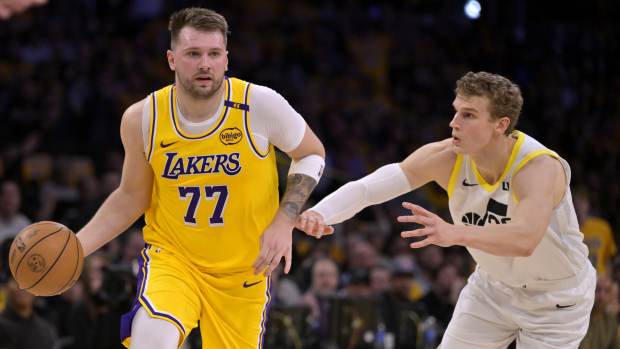 Los Angeles Lakers guard Luka Doncic (77) is defended by Utah Jazz forward Lauri Markkanen (23) in the first quarter at Crypto.com Arena. Mandatory Credit: Jayne Kamin-Oncea-Imagn Images